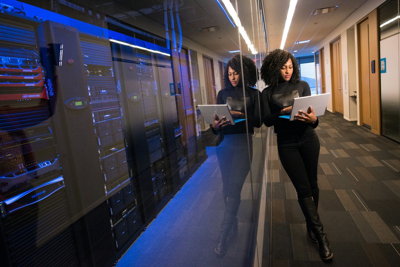 IT professional with a laptop in a secure server room